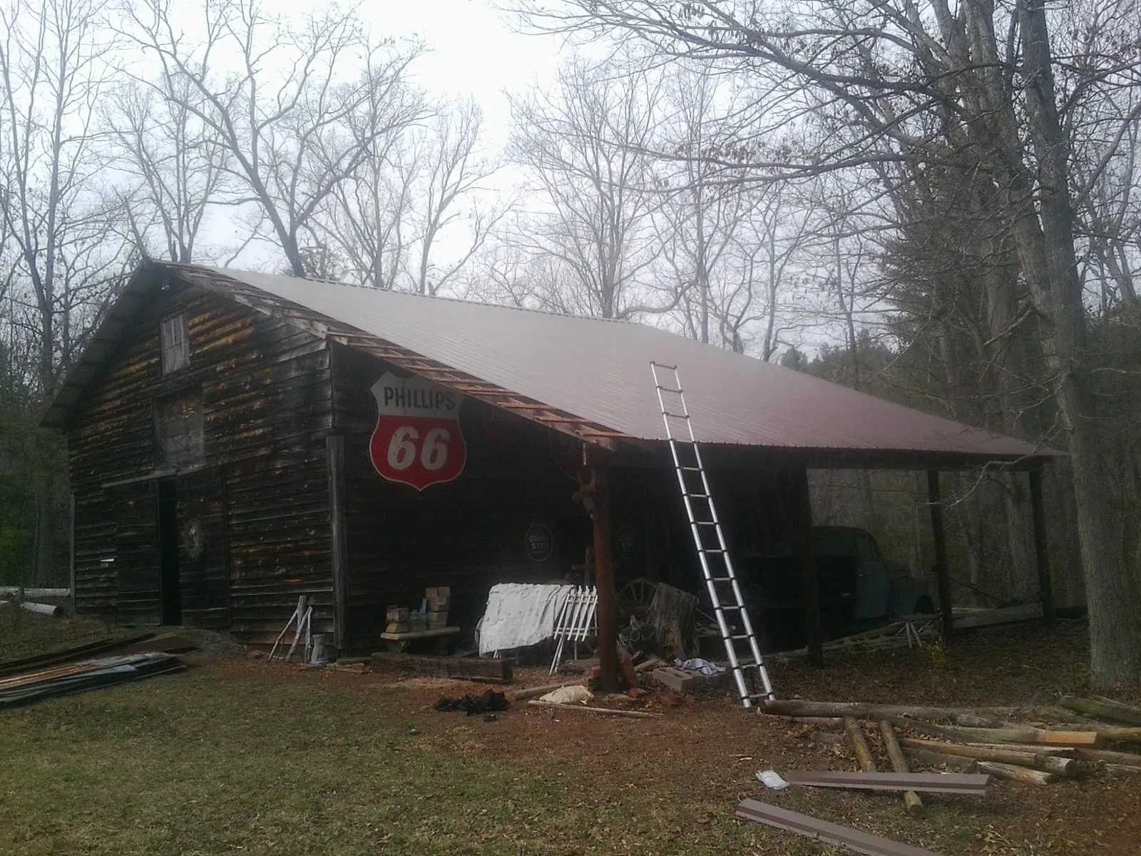 New metal roof on an open sided timber barn with a vintage sign in Granby
